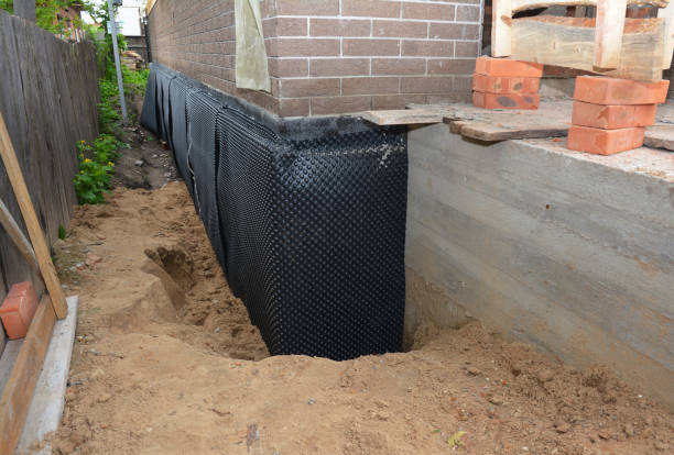 SJ Waterproofing Pros technician performing targeted Basement Waterproofing assessment in Burlington, KS